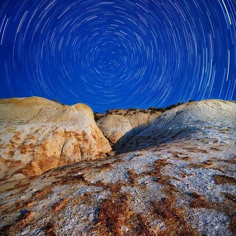 Star trails over rocky ridge — reel